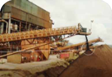 Photo of a large iron structure and mountains of sand in an area of ​​operation